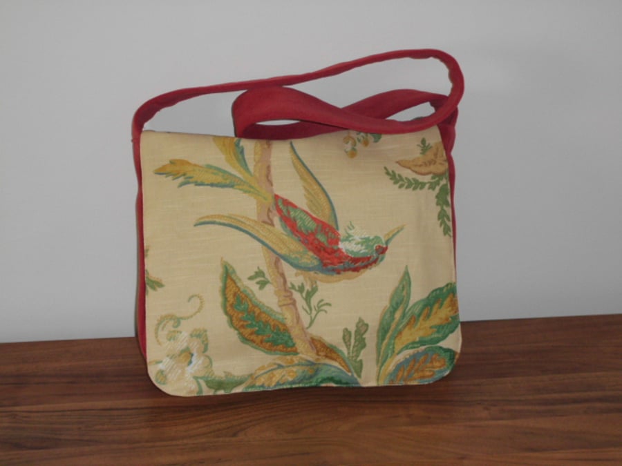 Red satchel messenger style bag with bird and floral front