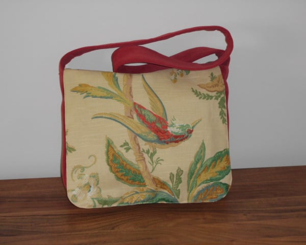 Red satchel messenger style bag with bird and floral front