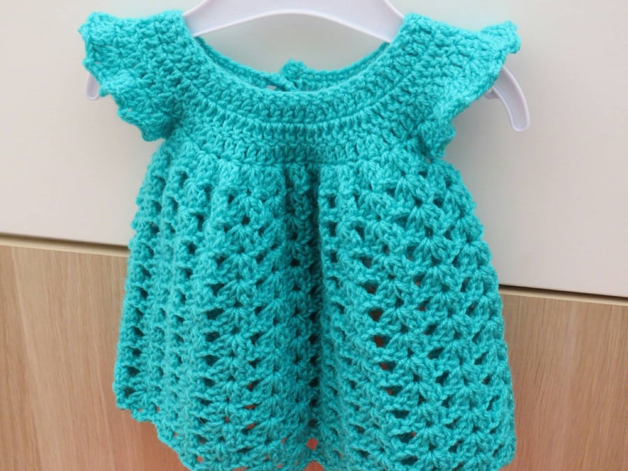 Green lacy baby girl's crocheted summer dress