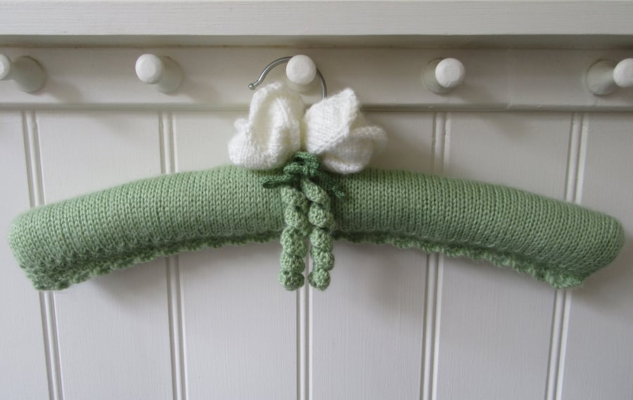 Hand knitted ladies coat hanger with white tulips
