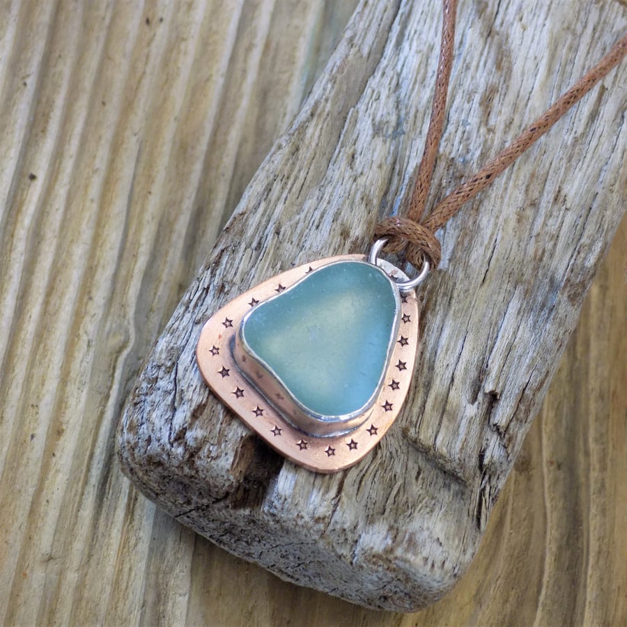 Copper and silver bezel set sea glass pendant 