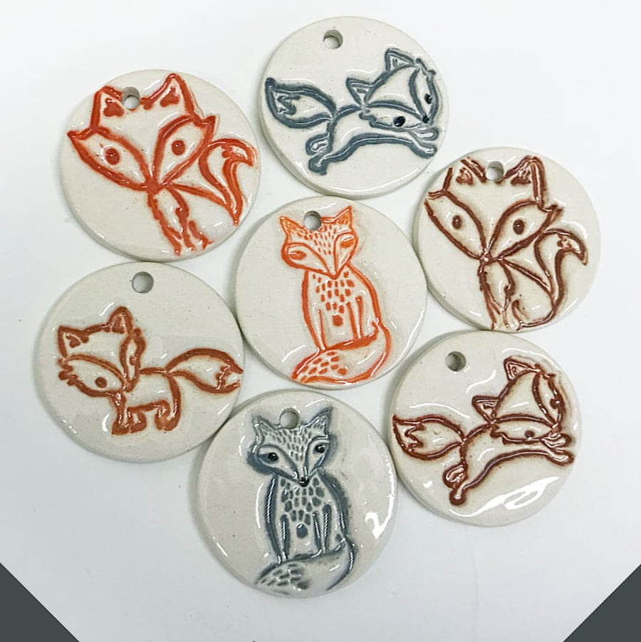 Set of seven ceramic fox pendants