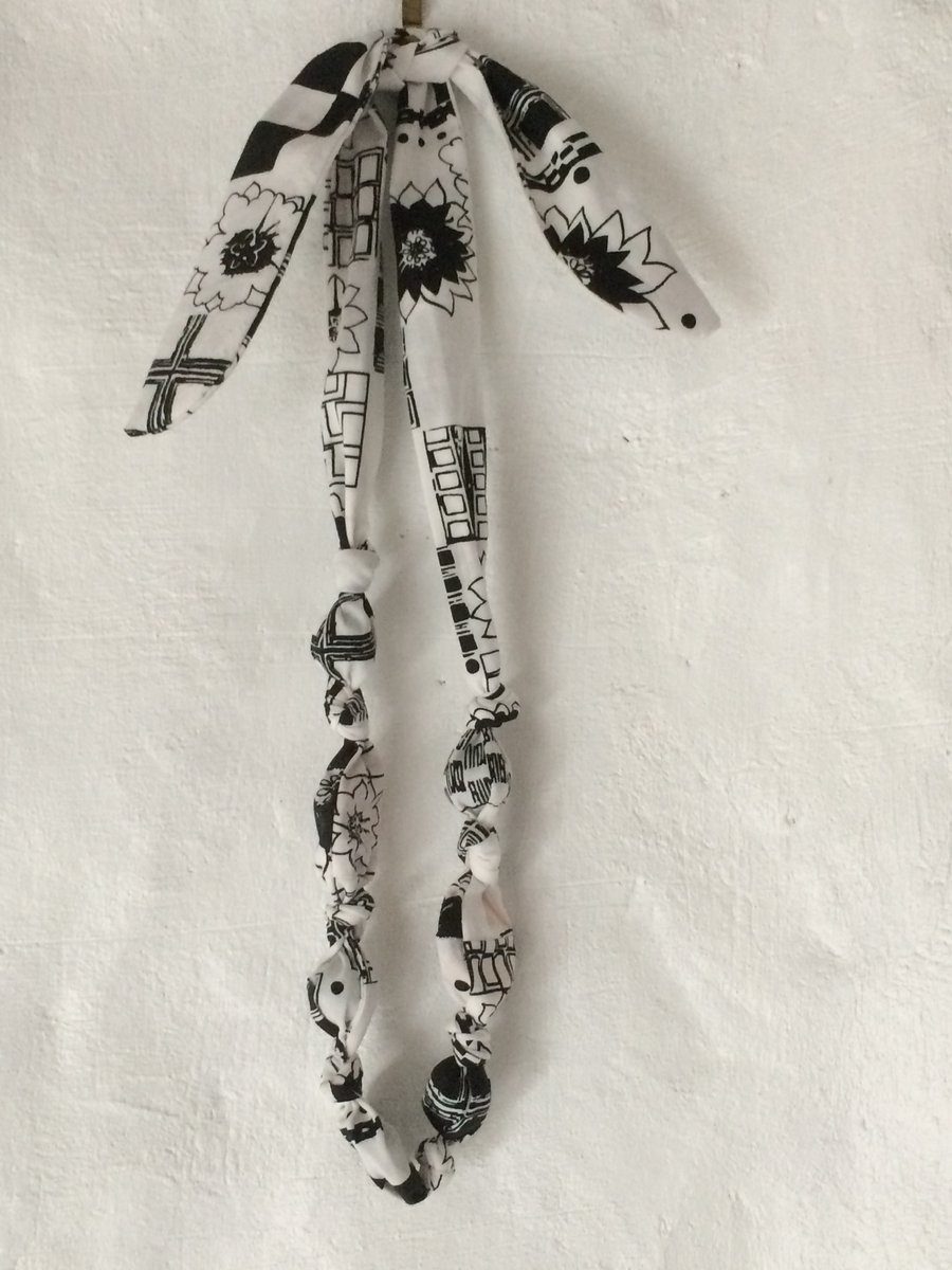 Simple tied teething necklace for nursing mothers.