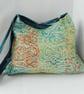 Pyramid shaped shoulder bag in coral colours