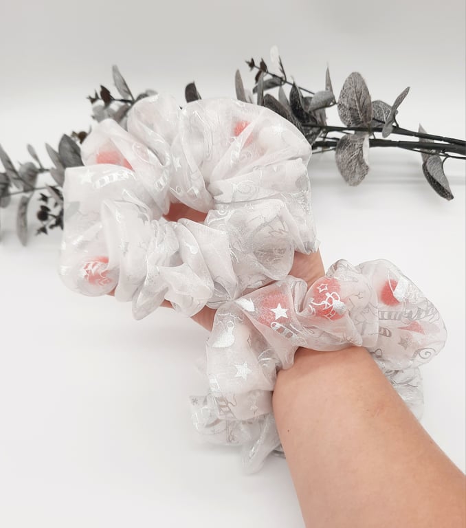 A pair of Christmas hair scrunchies, white and silver tulle.