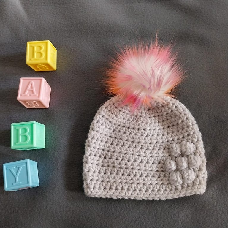 Light grey baby crocheted hat white faux fur pompom with orange purple & pink 