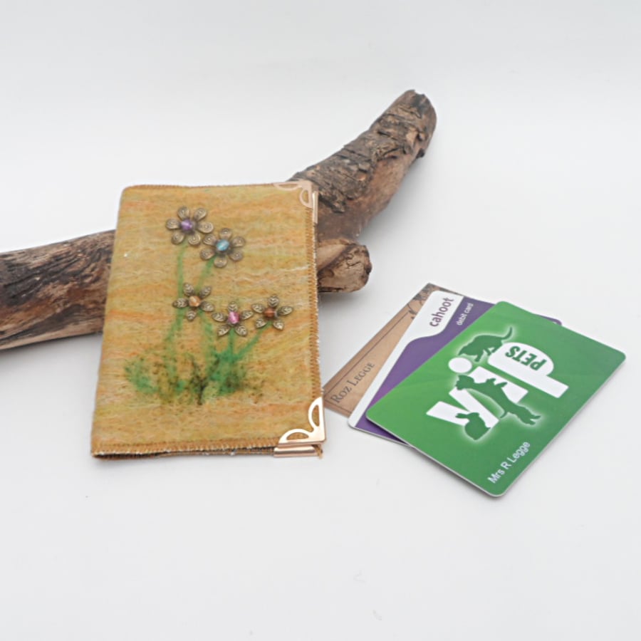 Orange felt covered card wallet with floral decoration