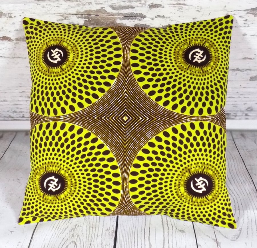 Cushion cover. African wax print, lime green and brown circles on khaki