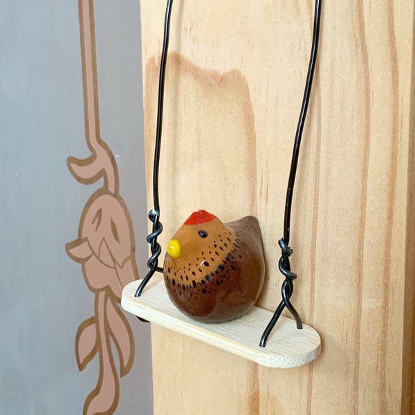 Miniature Chicken. Chicken On A Swing. Chickens. Hanging Decorations.