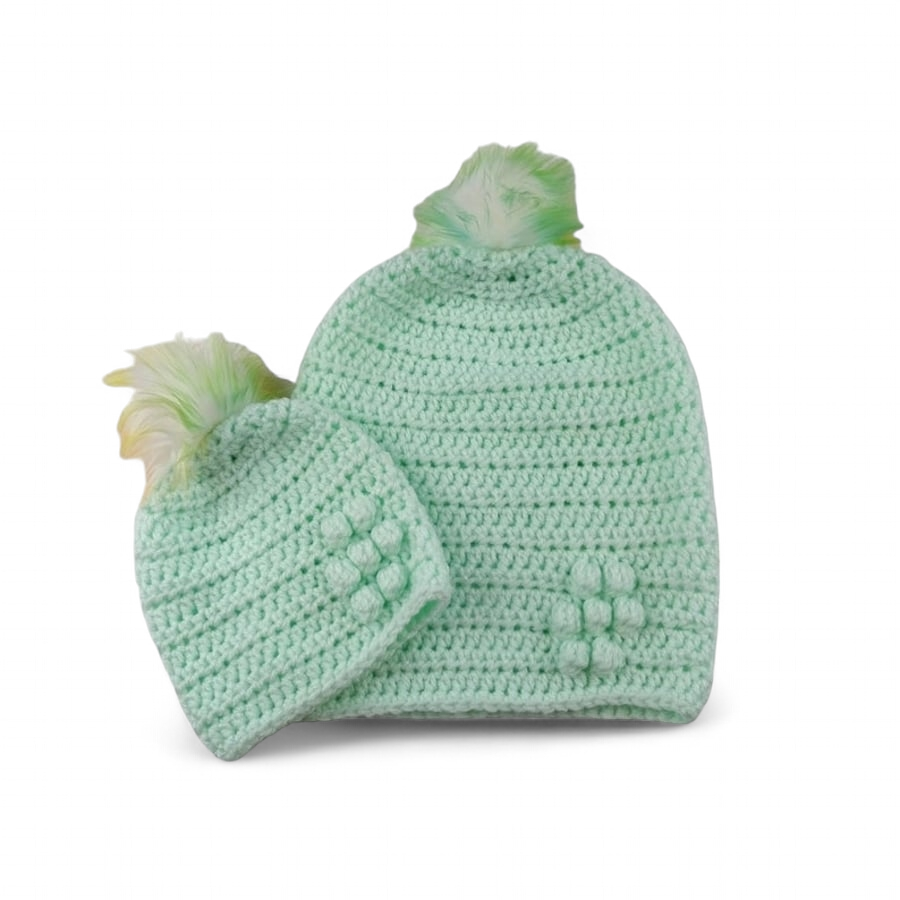 Matching ladies and baby green crocheted hats with detachable faux fur pompoms 