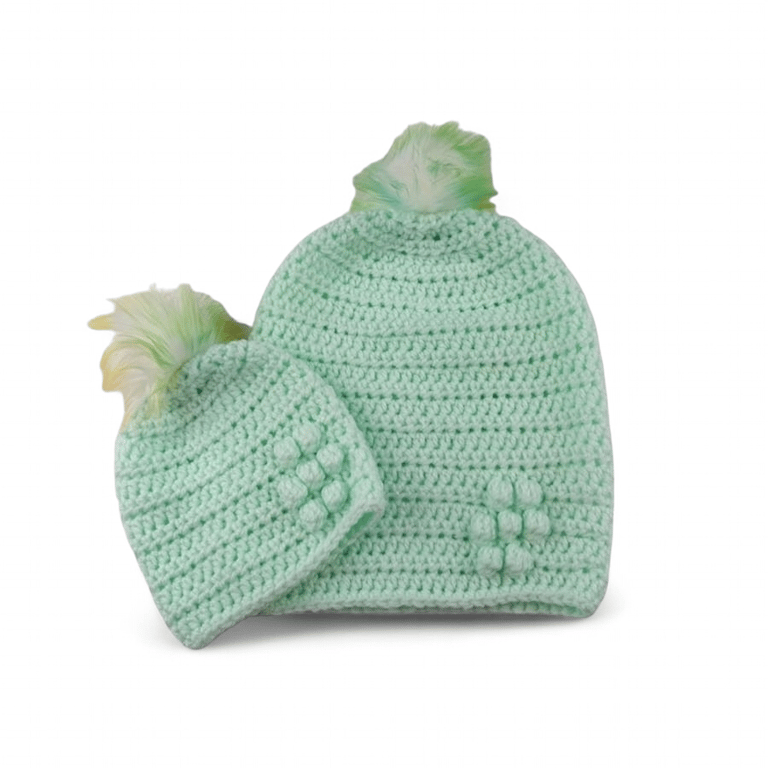Matching ladies and baby green crocheted hats with detachable faux fur pompoms 