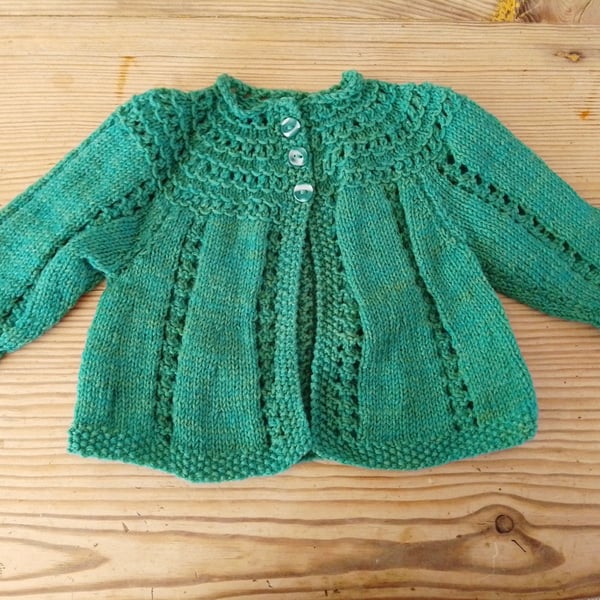 Baby cardigan in a green fleck yarn for age 3-6 months