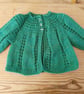 Baby cardigan in a green fleck yarn for age 3-6 months