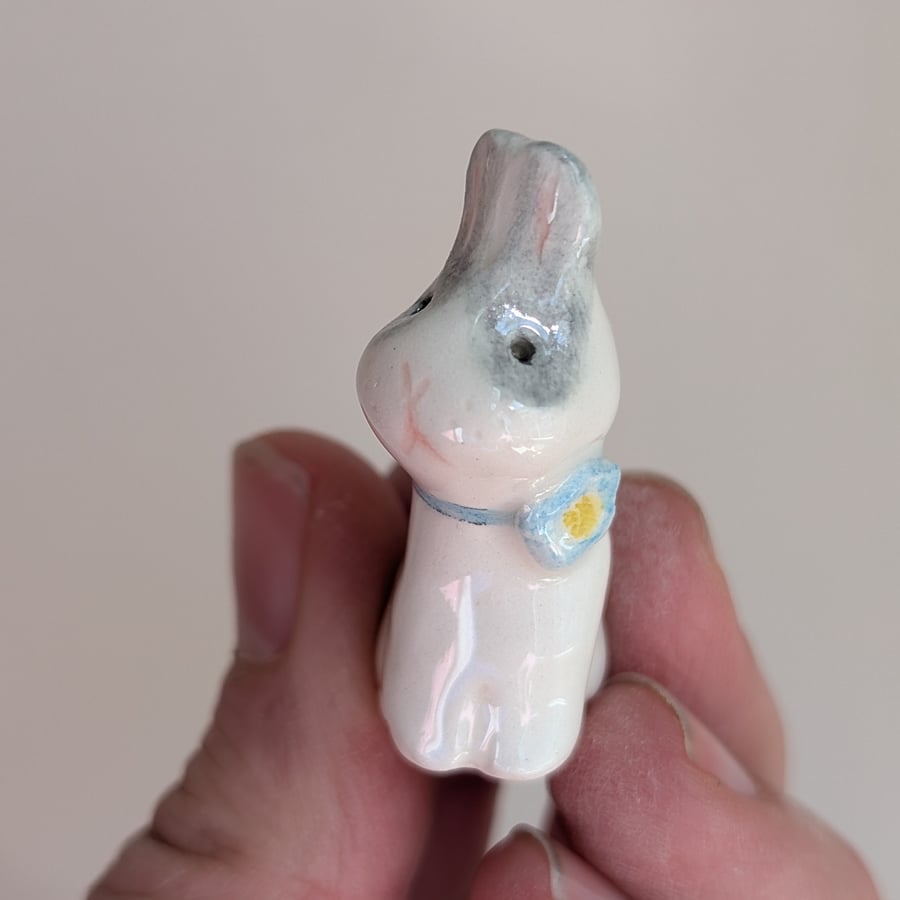 Grey and white bunny rabbit with forget me not flower ceramic figurine 
