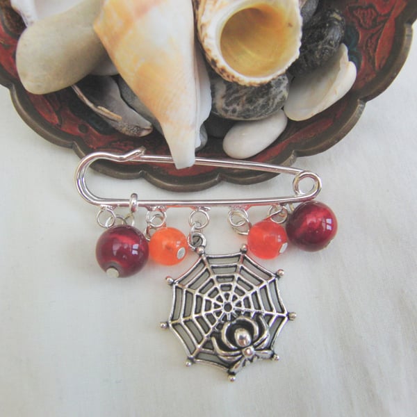 SALE - Red and Orange Beads and a Silver Spider Web Charm Kilt Pin Brooch