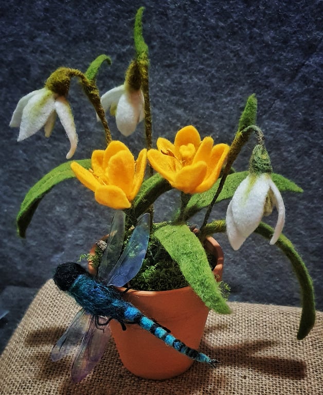 Needle felted Dragonfly perched on a terracotta pot full of snowdrops and crocus