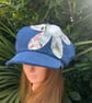 Women's denim Baker boy cap with decorative flower detail