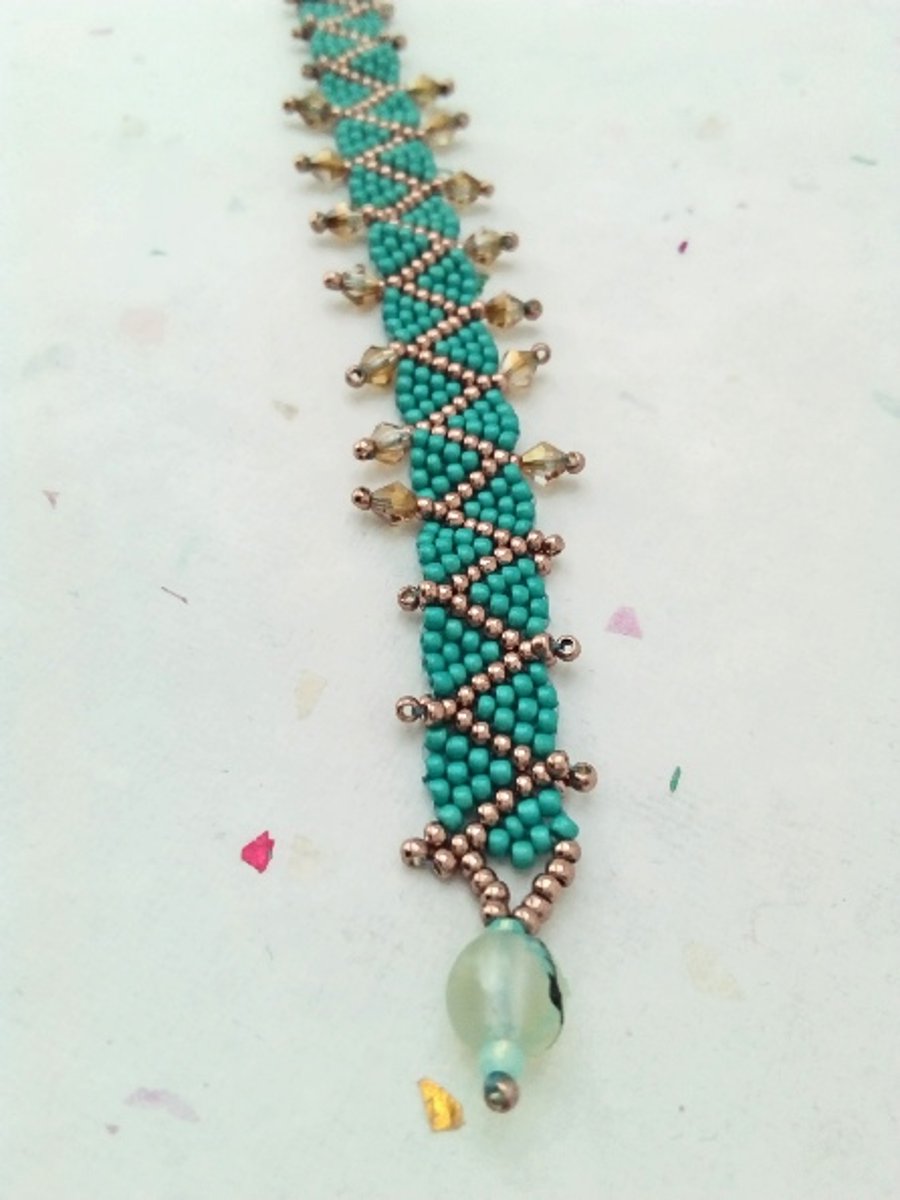 Teal and rose gold metallic zig zag, wavy beaded bracelet with sparkly crystals