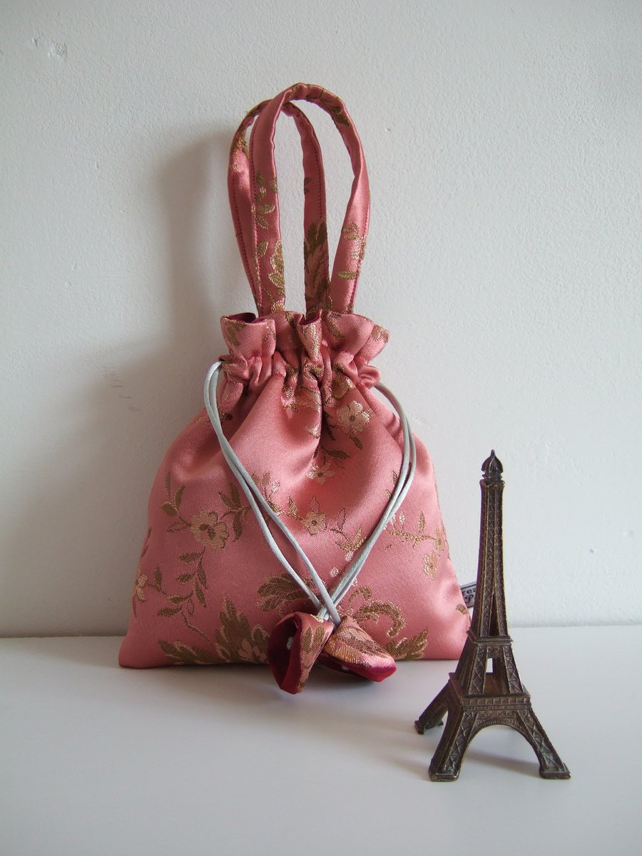 Drawstring bag with handles in pink vintage brocade.