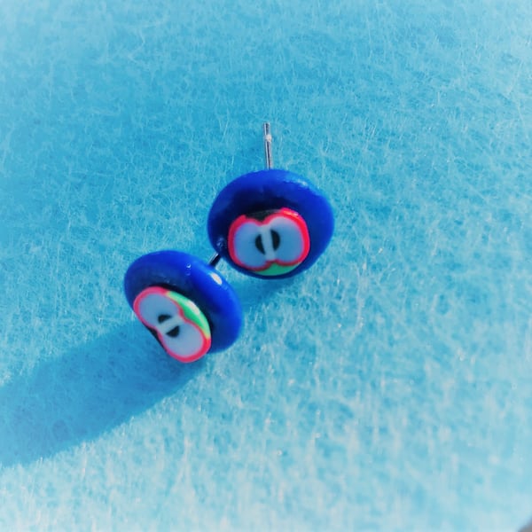Apple pip polymer clay stud earrings (blue background)