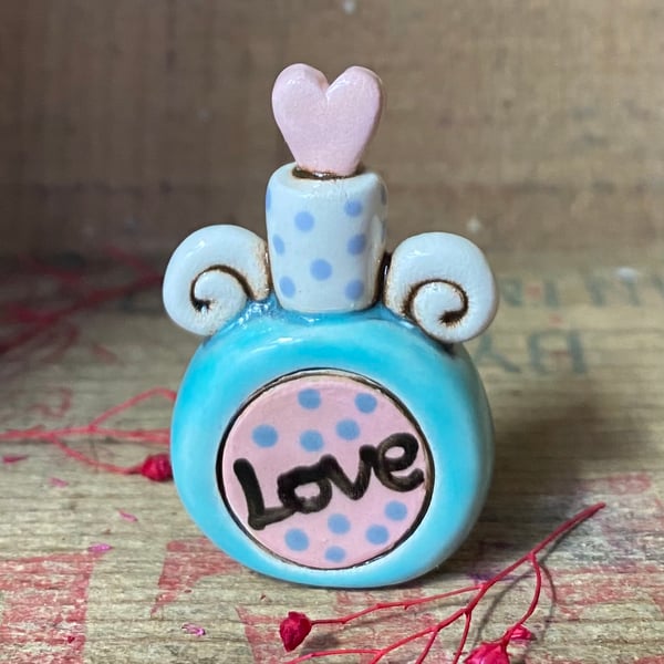 Teeny decorative ceramic love potion bottle. Blue