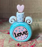 Teeny decorative ceramic love potion bottle. Blue