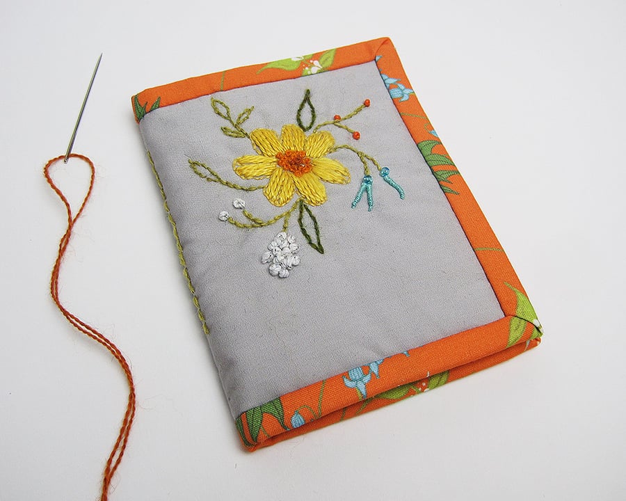 Grey needle case with hand embroidered spring flowers and orange trim