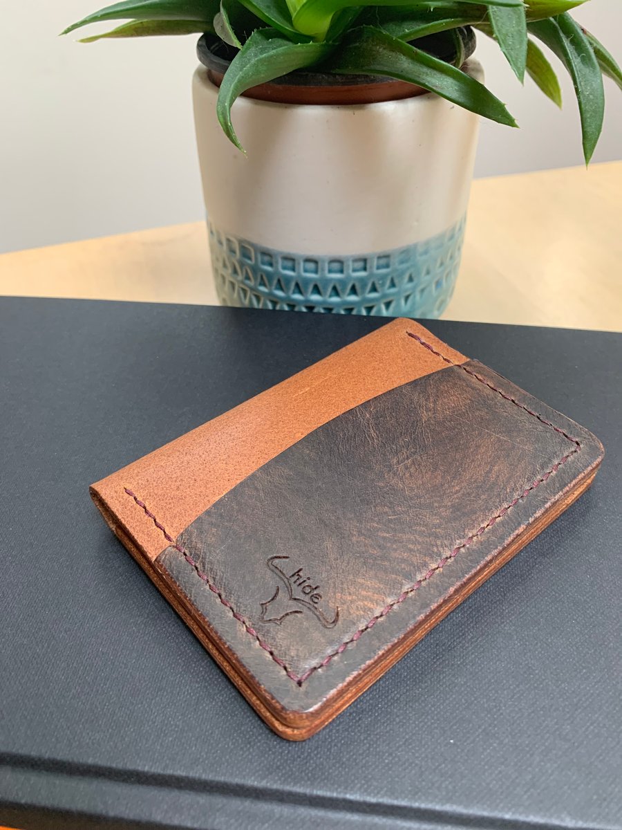 Leather wallet in brown and tan. Compact and slim for cards and cash 