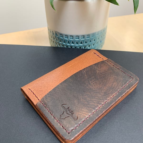 Leather wallet in brown and tan. Compact and slim for cards and cash 
