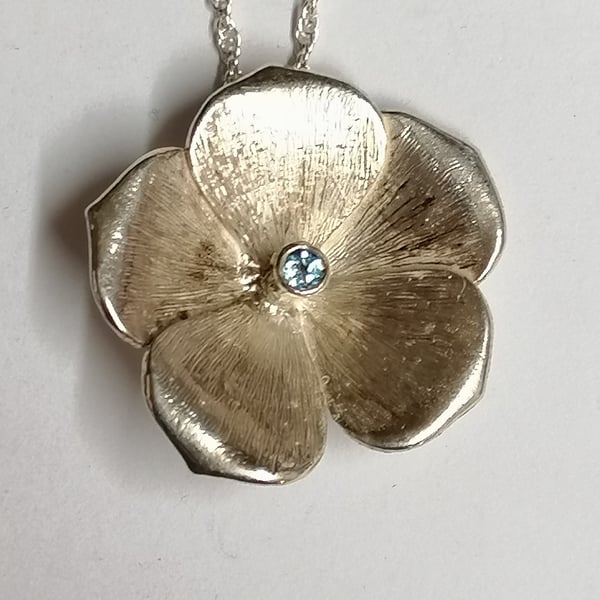Flax pendant hand made from Silver set with a Blue Topaz