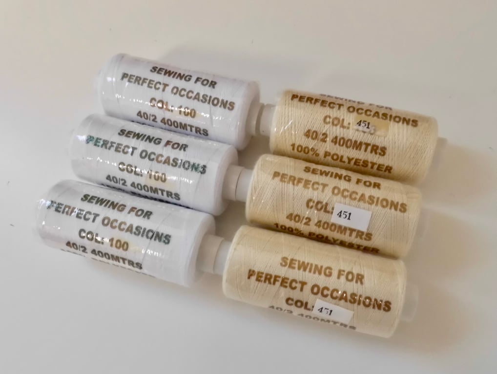 3 cream and 3 white reels of polyester sewing thread