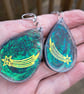 Shooting stars and green and black glitter oval shaped earrings