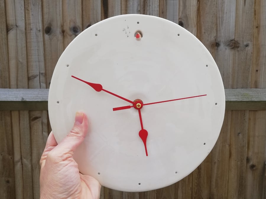 Ceramic clock with robin and musical notes. Red hands on white ceramic Wall art