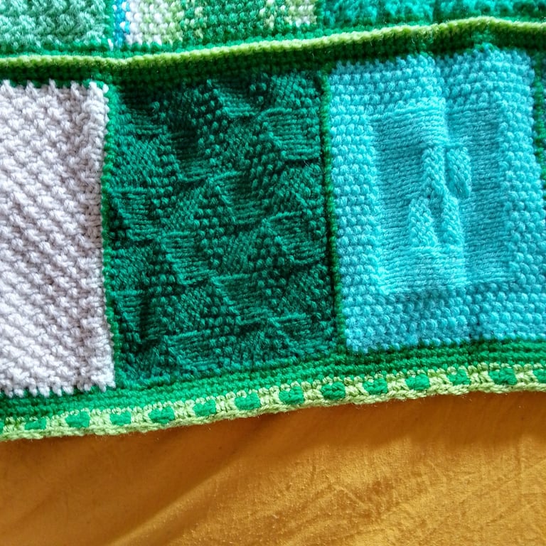 baby and toddler handmade knitted baby blanket in green colourway.