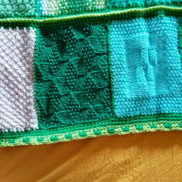 baby and toddler handmade knitted baby blanket in green colourway.