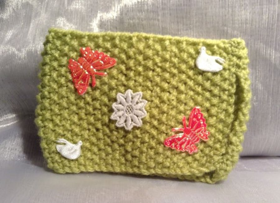 Little green decorative knitted mug warmer