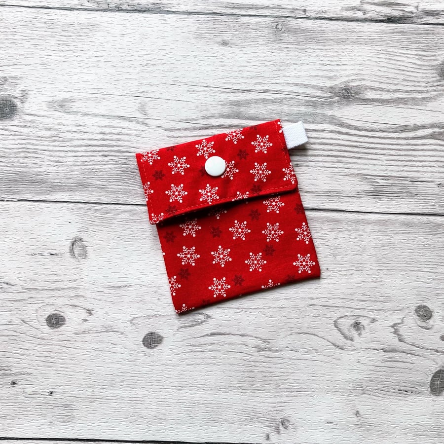 Snowflake Christmas themed red cotton fabric gift bags with snap closure. 