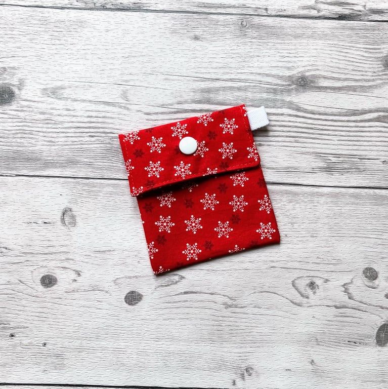 Snowflake Christmas themed red cotton fabric gift bags with snap closure. 