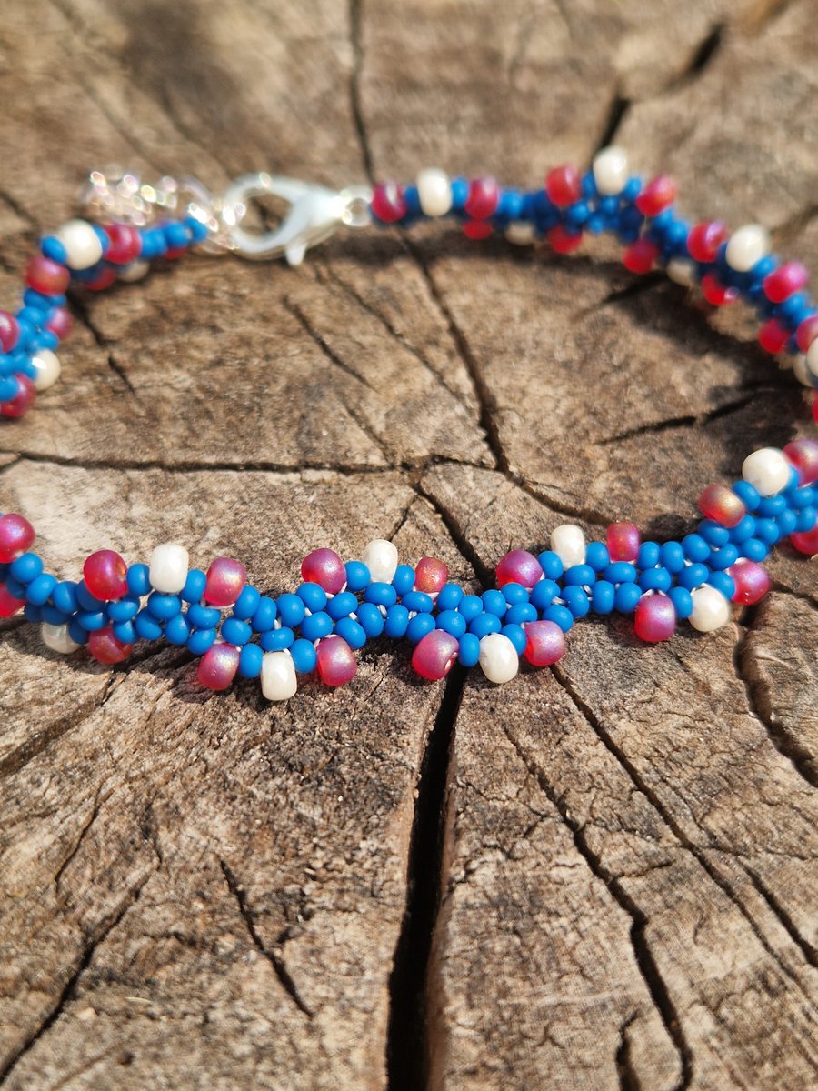 Wavy blue bracelet with red and white accent beads