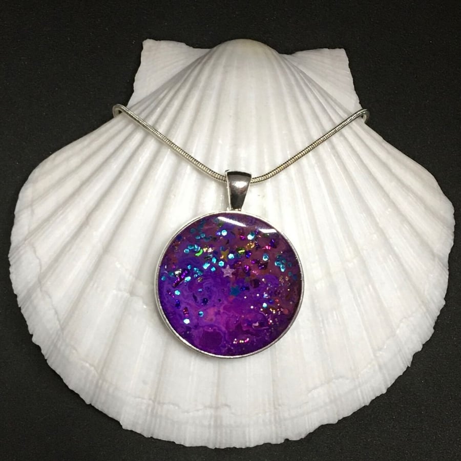 Purple and pink galaxy pendant with resin and alcohol inks.