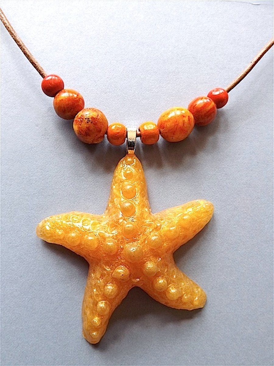 Starfish pendant necklace,  gold mica resin and polymer clay beads on leather.