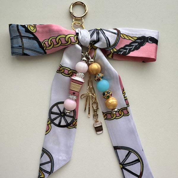Hand crafted bag charm features a satin scarf bow, beaded dangles 