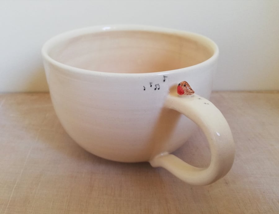 Handmade robin mug FOR H in white clay, whistling bird and footprints