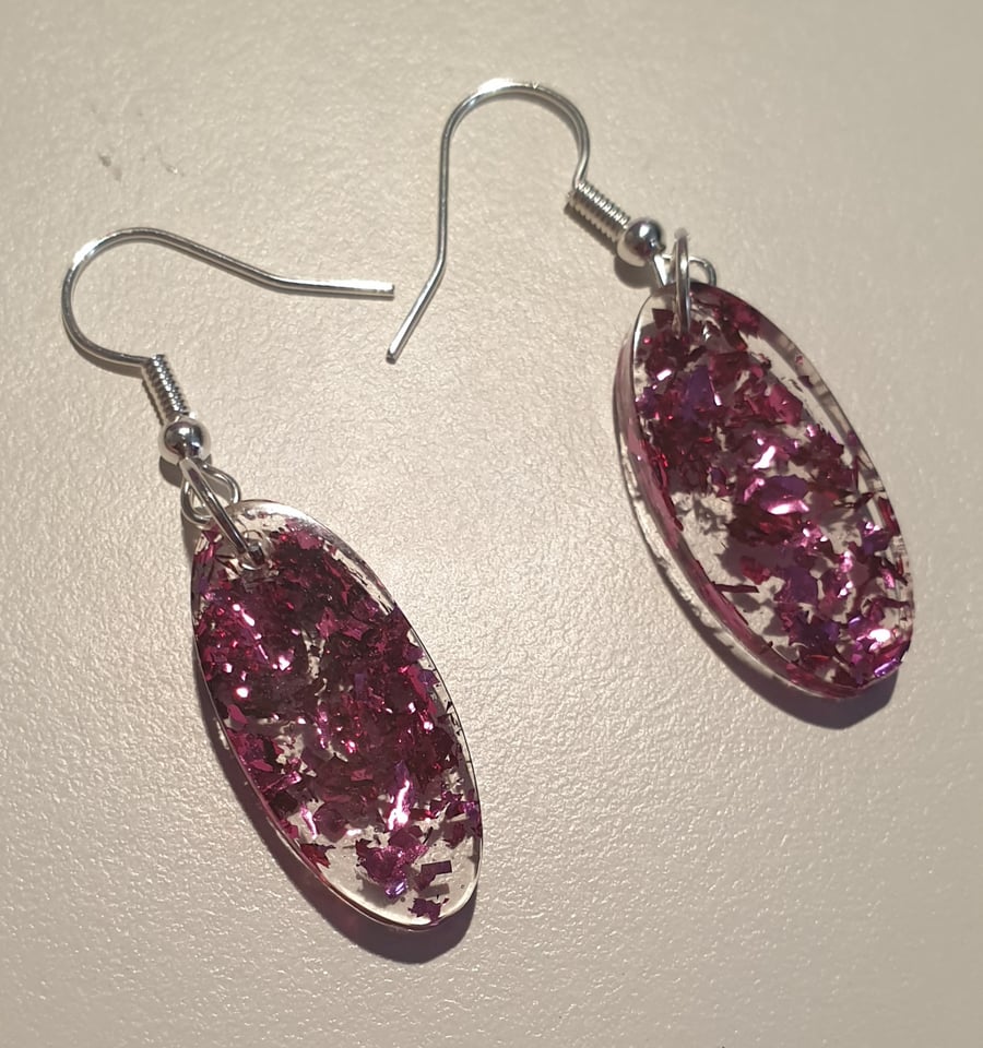 Oval pink metallic flakes resin earrings