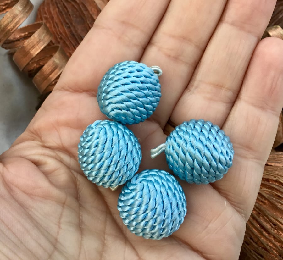 Set of Four Silk Cord Covered Globe Toggle Buttons.