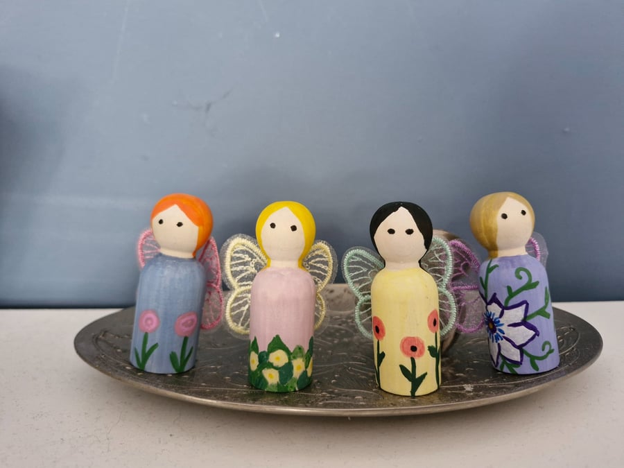 Set of four flower fairy peg dolls.
