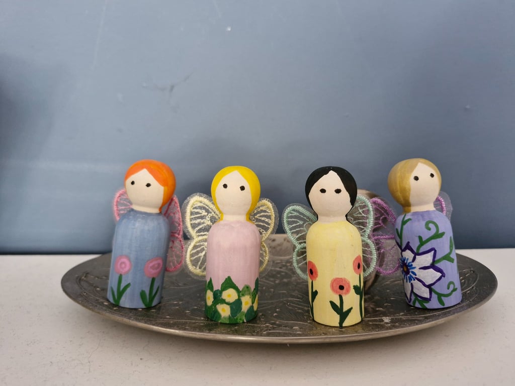 Set of four flower fairy peg dolls.