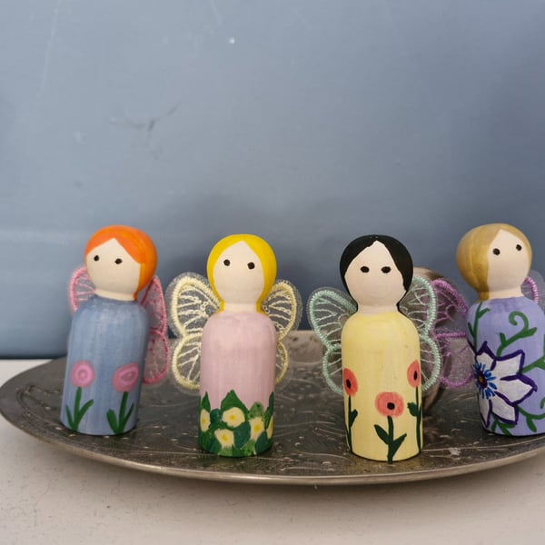 Set of four flower fairy peg dolls.