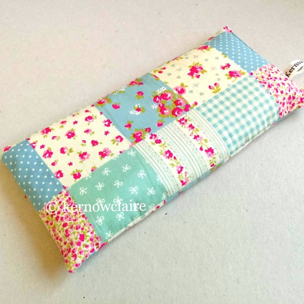Lavender eye pillow in peach with turquoise flowers