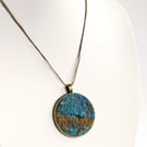 Felted pendant - tuquoises and orange in a bronze bezel